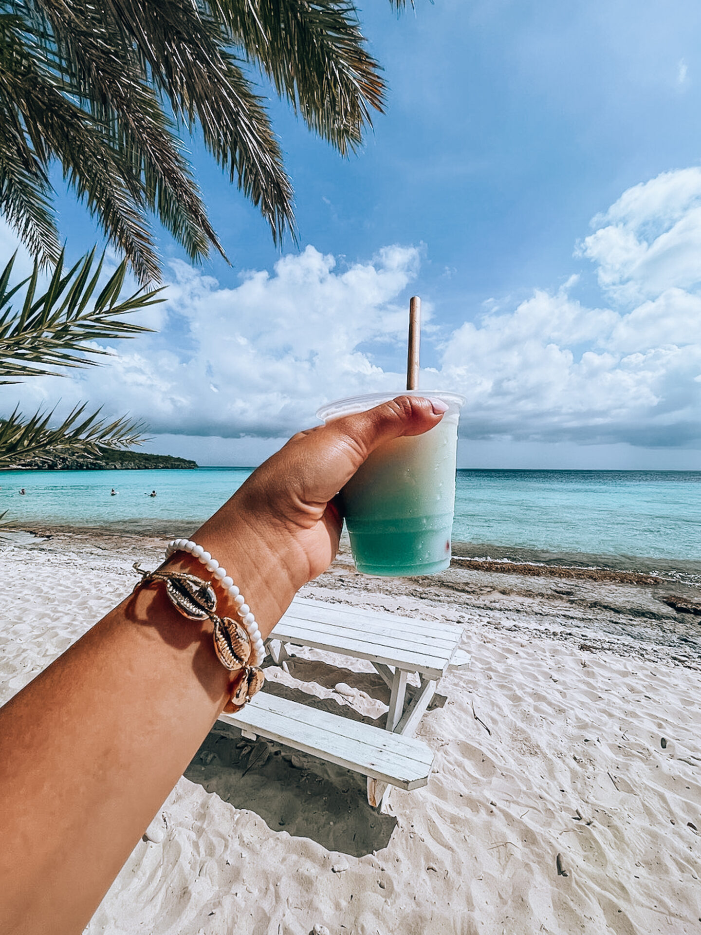 pina colada made from curacao blue against turquoise waters of this famous beach in curacao